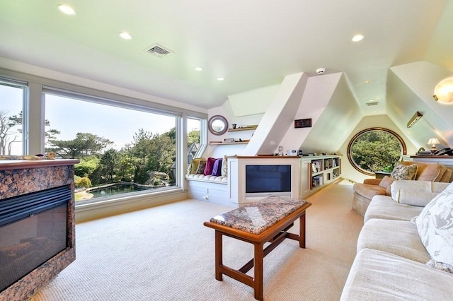 carpeted living room featuring lofted ceiling