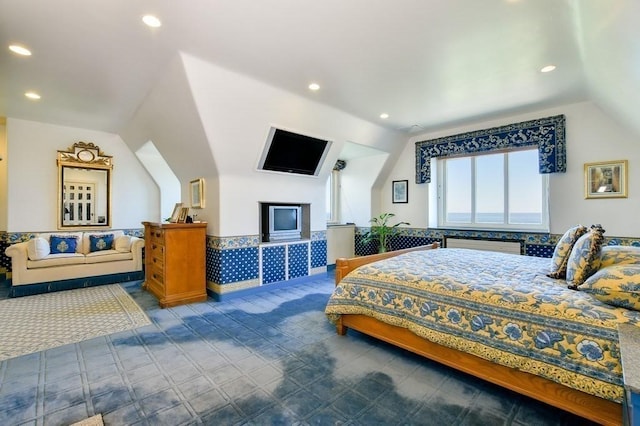 bedroom with lofted ceiling and dark tile floors