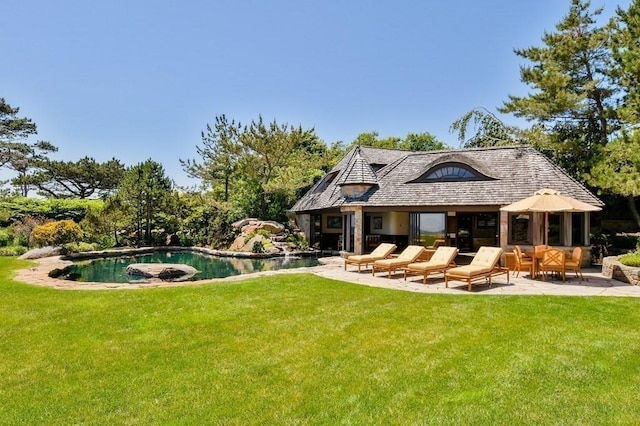 rear view of property with a patio area and a yard