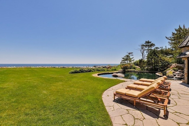 exterior space with a water view and a patio