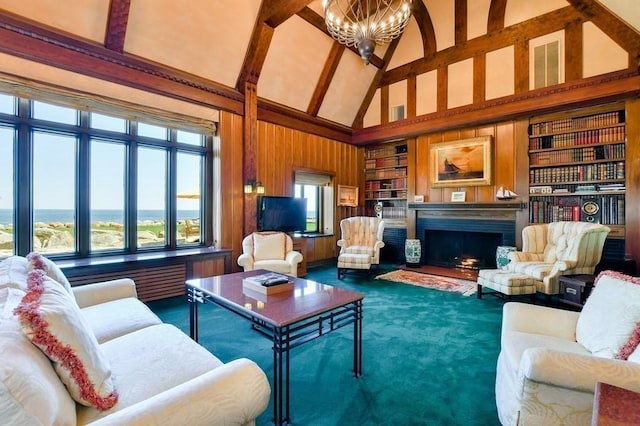 living room with plenty of natural light, a chandelier, built in features, dark carpet, and high vaulted ceiling