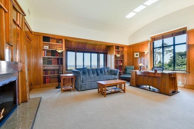 carpeted living room featuring lofted ceiling, built in shelves, and wood walls