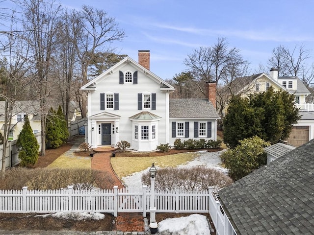 view of front of property with a fenced front yard and a chimney