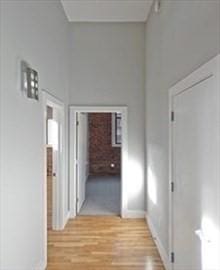 hall with light hardwood / wood-style flooring