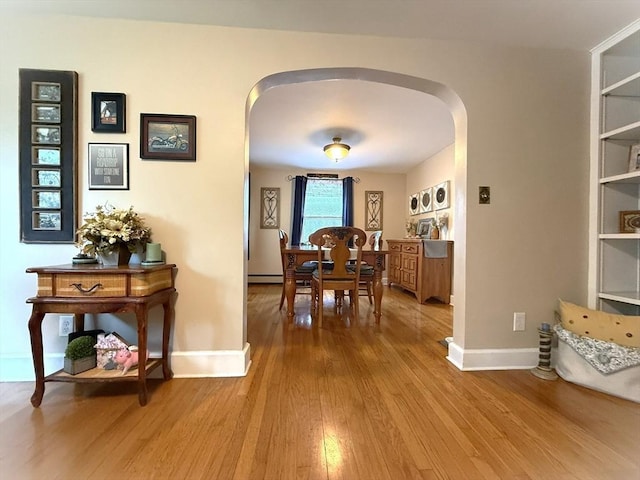 4 Perryville Rd, Webster, MA 01570 - dining area featuring arched walkways, wood finished floors, and baseboards