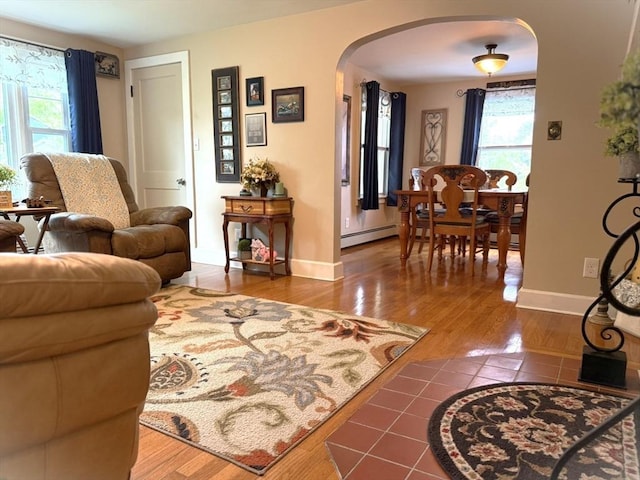 4 Perryville Rd, Webster, MA 01570 - living room with arched walkways, plenty of natural light, wood finished floors, and baseboards