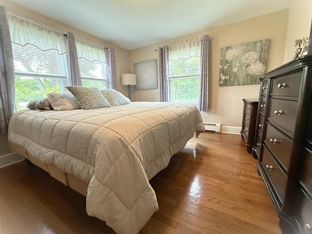 4 Perryville Rd, Webster, MA 01570 - bedroom featuring a baseboard radiator, baseboards, and wood finished floors