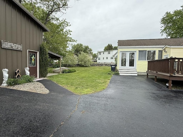 4 Perryville Rd, Webster, MA 01570 - view of green lawn with a wooden deck and french doors