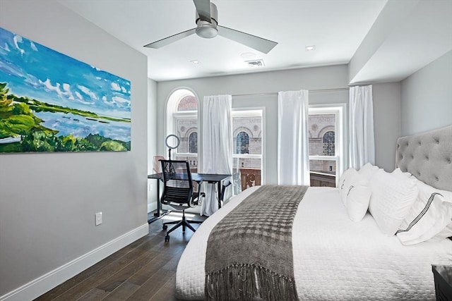 bedroom with dark hardwood / wood-style flooring and ceiling fan