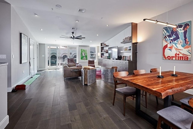 dining area with ceiling fan and dark hardwood / wood-style floors