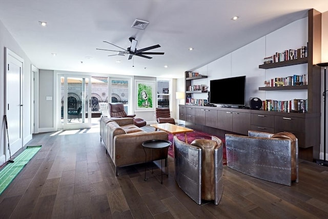 living room featuring ceiling fan and dark hardwood / wood-style flooring