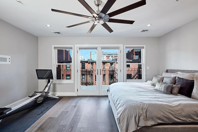 bedroom with dark hardwood / wood-style flooring, access to exterior, and ceiling fan