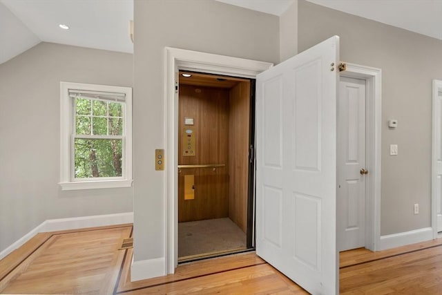21 Musquashicut Ave Unit 27, Scituate, MA 02066 - hallway with light wood-style floors, baseboards, elevator, recessed lighting, and vaulted ceiling