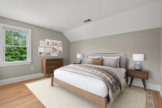 21 Musquashicut Ave Unit 27, Scituate, MA 02066 - bedroom with wood finished floors, baseboards, and vaulted ceiling