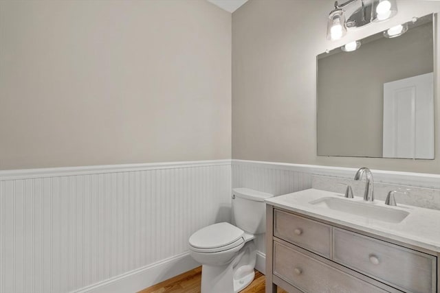 21 Musquashicut Ave Unit 27, Scituate, MA 02066 - bathroom featuring a wainscoted wall, vanity, toilet, and wood finished floors