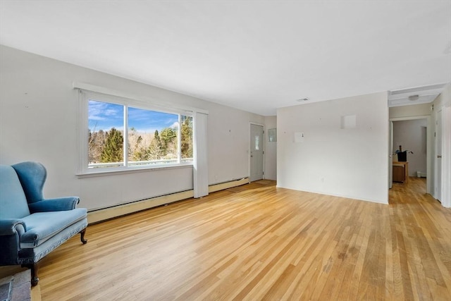 living room featuring light hardwood / wood-style flooring and a baseboard heating unit