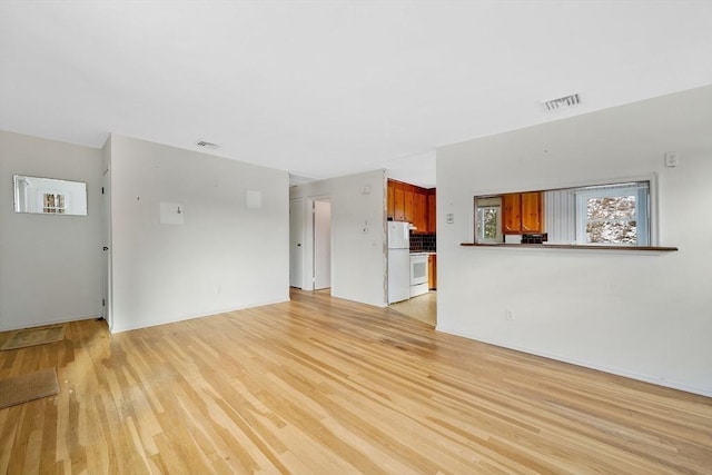 unfurnished living room with light wood-type flooring