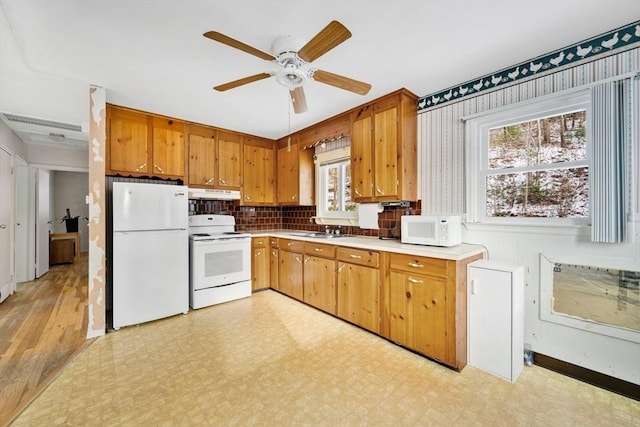 kitchen with white appliances, tasteful backsplash, ceiling fan, and sink