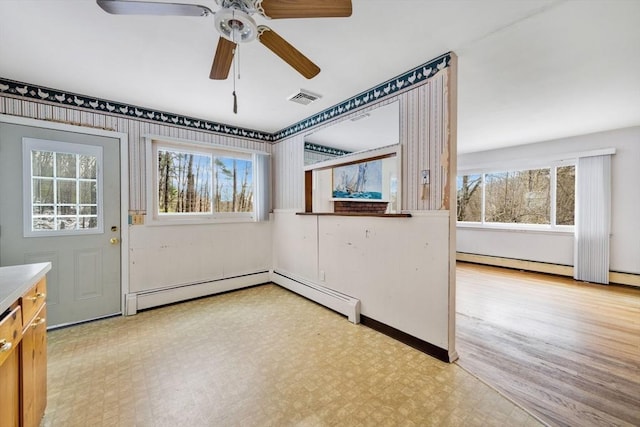 unfurnished room featuring ceiling fan and plenty of natural light