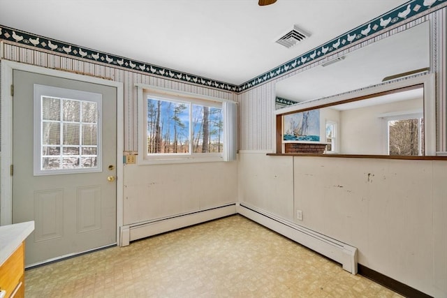 interior space featuring a baseboard radiator and a healthy amount of sunlight