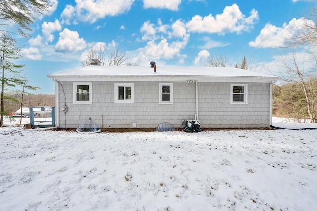 snow covered house with central AC