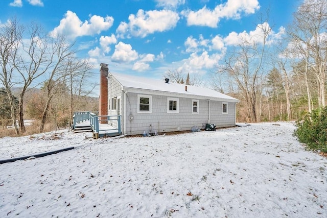 snow covered property featuring a deck