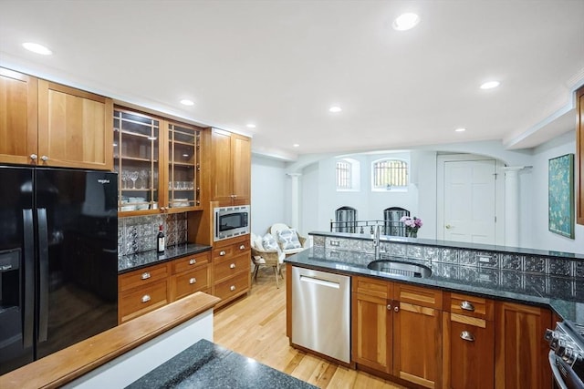 44 Dartmouth St Unit 1, Boston, MA 02116 - kitchen featuring a sink, decorative columns, light wood-type flooring, arched walkways, and stainless steel appliances