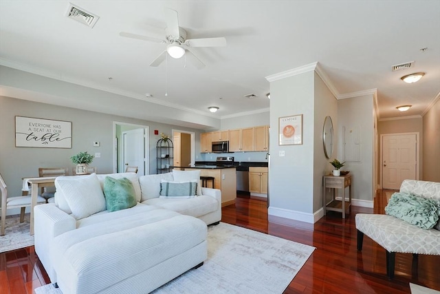 living room with ceiling fan, ornamental molding, and dark hardwood / wood-style floors