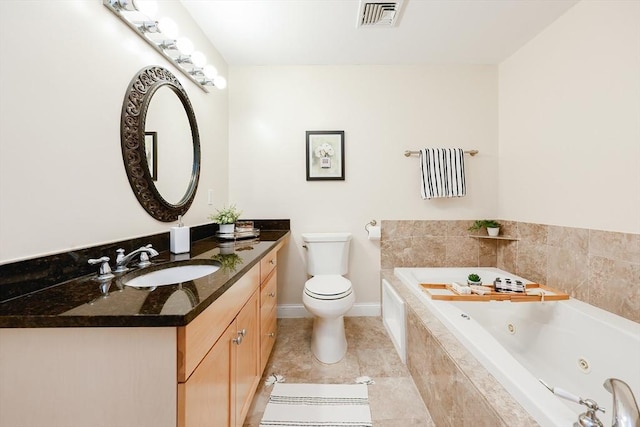 bathroom with toilet, vanity, and a relaxing tiled tub