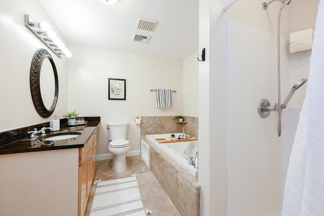 bathroom featuring toilet, tile patterned flooring, tiled tub, and vanity