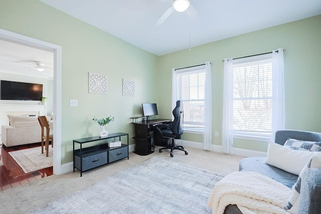 carpeted home office with ceiling fan