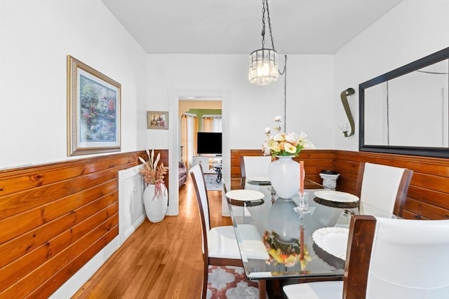 209 Grove St, Brockton, MA 02302 - dining room with light wood finished floors, a wainscoted wall, and a chandelier