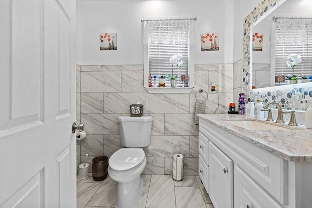 209 Grove St, Brockton, MA 02302 - bathroom with tile walls, vanity, toilet, and a wainscoted wall