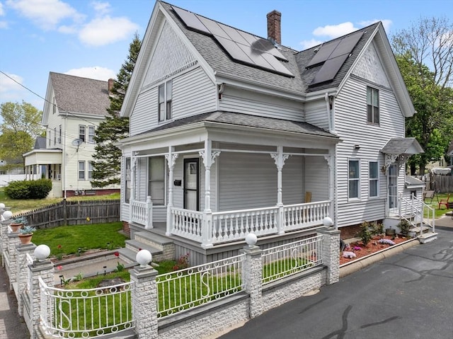 209 Grove St, Brockton, MA 02302 - victorian home featuring a porch, solar panels, a chimney, and a shingled roof