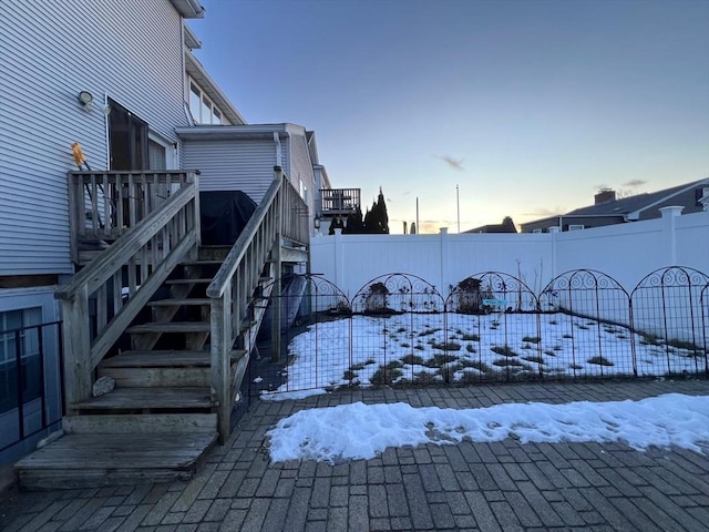 yard layered in snow featuring a wooden deck