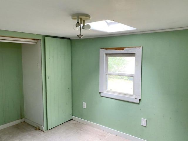 unfurnished bedroom featuring a skylight