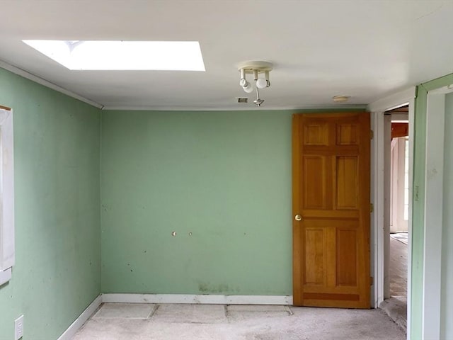 unfurnished room with a skylight