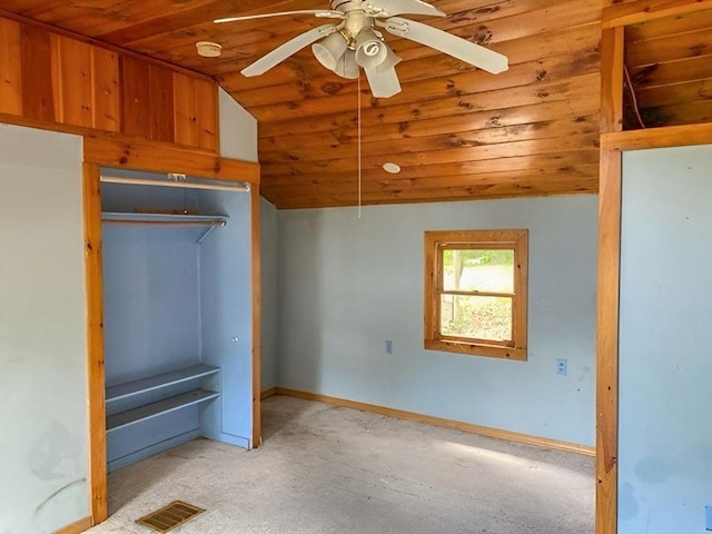 unfurnished bedroom with a closet, vaulted ceiling, ceiling fan, and wooden ceiling