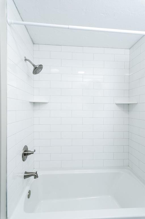 bathroom featuring tiled shower / bath