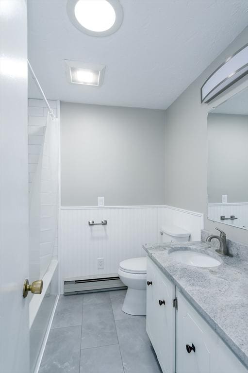 full bathroom featuring toilet, baseboard heating, shower / bath combination with curtain, and vanity