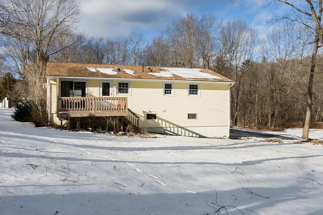 snow covered property featuring a wooden deck