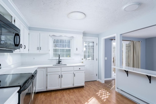 kitchen with stainless steel appliances, sink, white cabinetry, light hardwood / wood-style flooring, and a baseboard heating unit