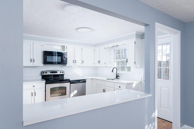 kitchen with light hardwood / wood-style flooring, backsplash, white cabinetry, appliances with stainless steel finishes, and sink