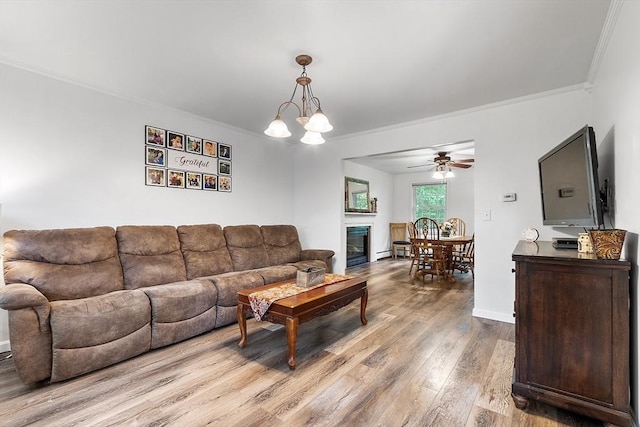 935 Old Keene Rd, Athol, MA 01331 - living room with crown molding, wood finished floors, a ceiling fan, and a glass covered fireplace