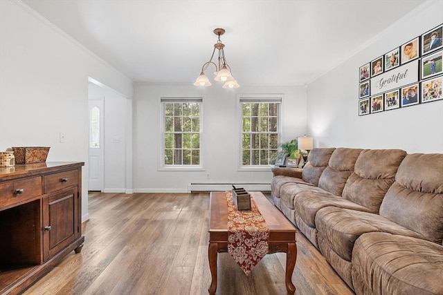 935 Old Keene Rd, Athol, MA 01331 - living room featuring light wood-type flooring, crown molding, a baseboard radiator, and a chandelier