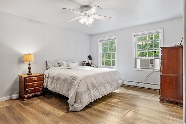935 Old Keene Rd, Athol, MA 01331 - bedroom featuring a baseboard radiator, wood finished floors, cooling unit, and ceiling fan