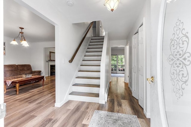 935 Old Keene Rd, Athol, MA 01331 - foyer entrance featuring stairs, wood finished floors, a fireplace, and a chandelier