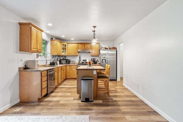 935 Old Keene Rd, Athol, MA 01331 - kitchen featuring appliances with stainless steel finishes, under cabinet range hood, a kitchen island, light wood-type flooring, and recessed lighting