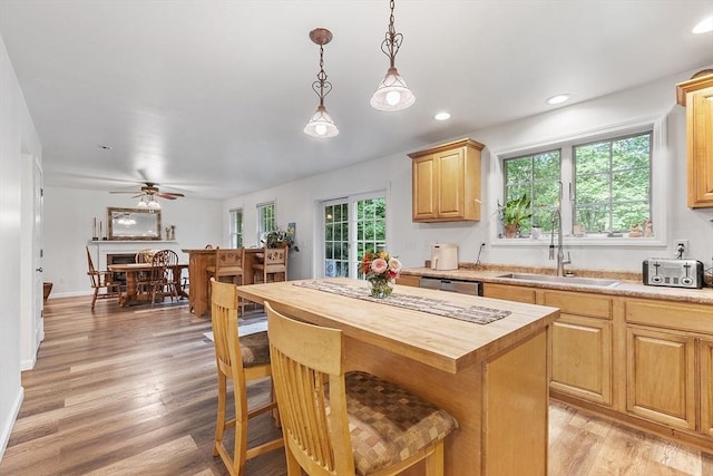 935 Old Keene Rd, Athol, MA 01331 - kitchen featuring butcher block counters, a kitchen bar, ceiling fan, light wood finished floors, and pendant lighting