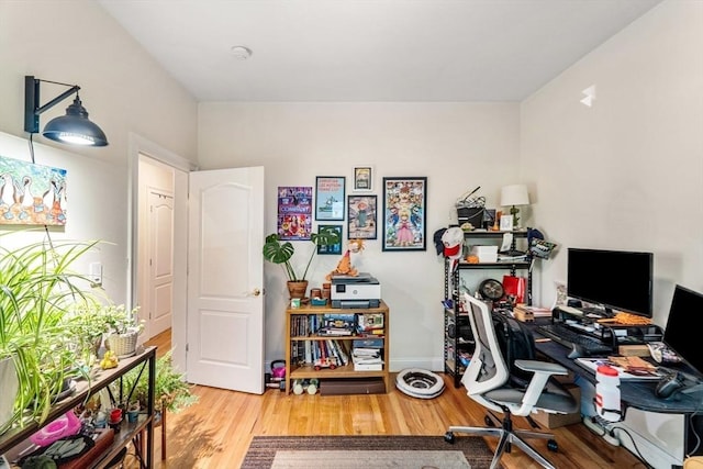 home office featuring wood finished floors and baseboards